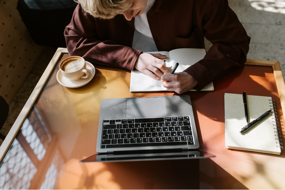 A sunlit editorial workspace viewed from above